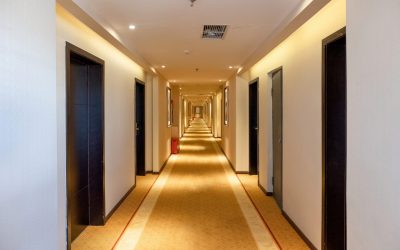 hallway straight with the door and golden lighting illuminated i